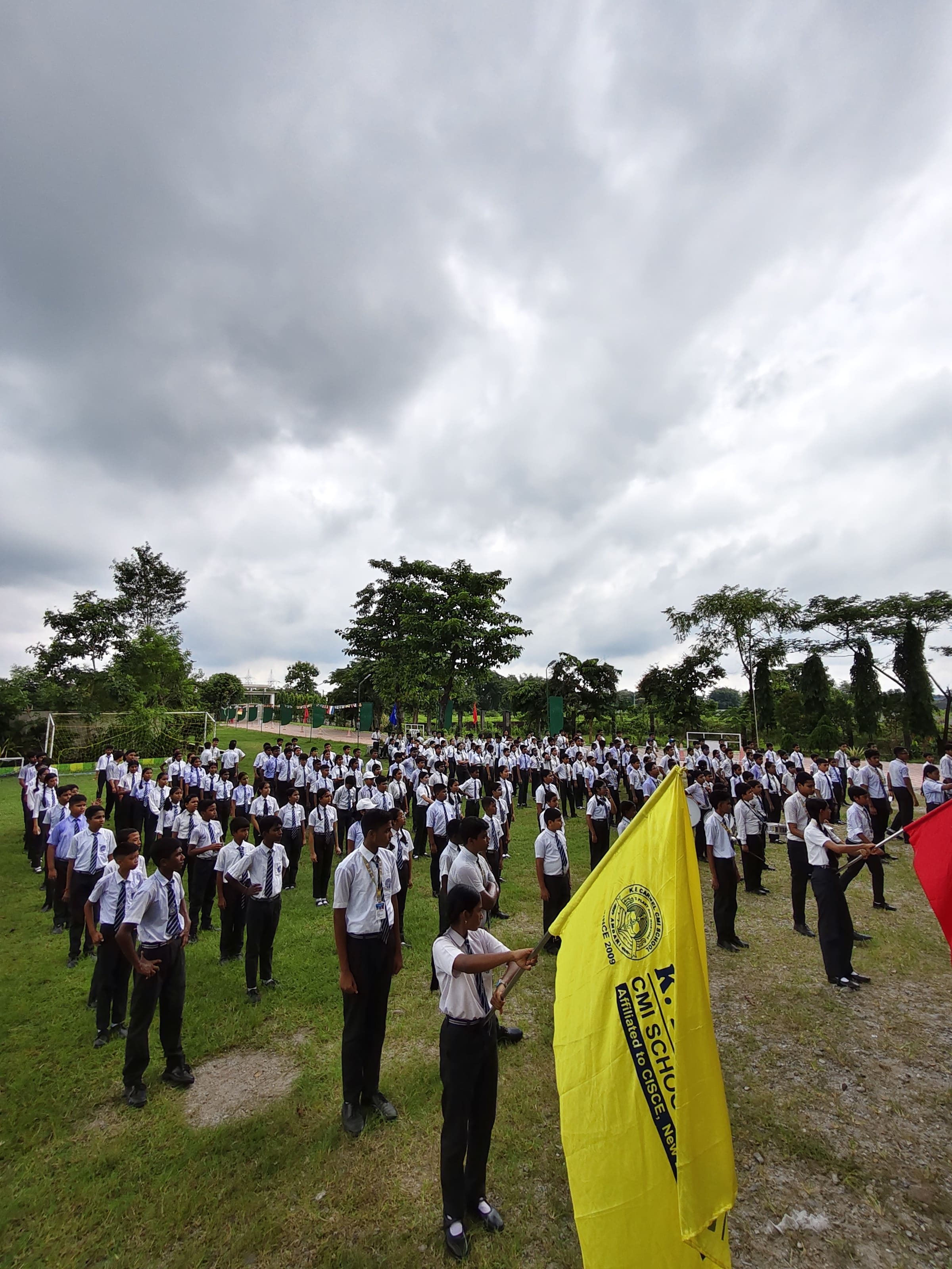 Large school assembly in the campus courtyard